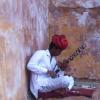 A man playing the chikara instrument in amber fort